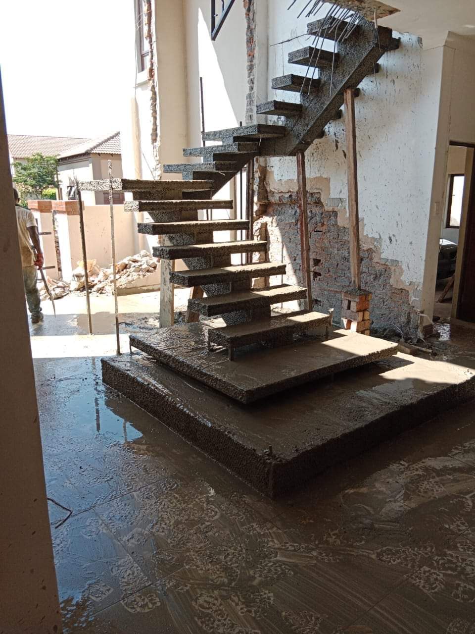 Custom floating concrete staircase built by Shape & Smart